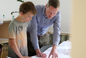 Schüler Laurenz Finkenberg (links) schnupperte einen Tag lang Arbeitsluft im Bauamt des Landratsamtes Würzburg. Sein Lohn wird für einen guten Zweck gespendet. Fachbereichsleiter Christoph Schmelz erklärte ihm die Arbeit der Behörde und erklärte ihm unter anderem, wie Baupläne zu lesen sind. Foto: Tim Großmüller